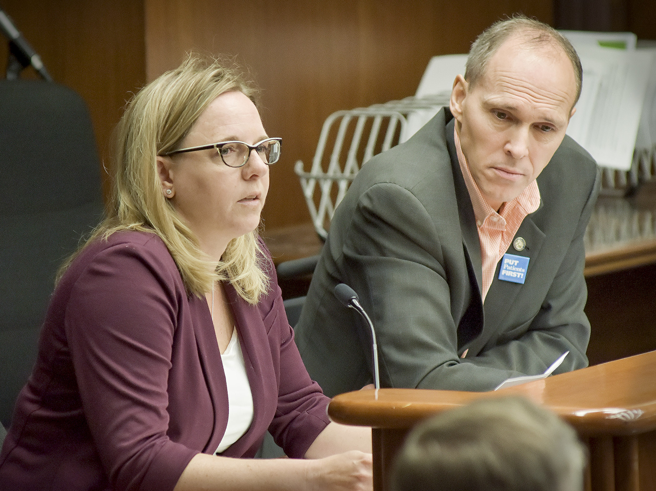 Dr. Julie Anderson, a family medicine physician in St. Cloud, testifies before the House Health and Human Services Finance Committee May 17 in support of a bill sponsored by Rep. Rod Hamilton, right, that would modify prior authorization requirements for prescription drug coverage. Photo by Andrew VonBank